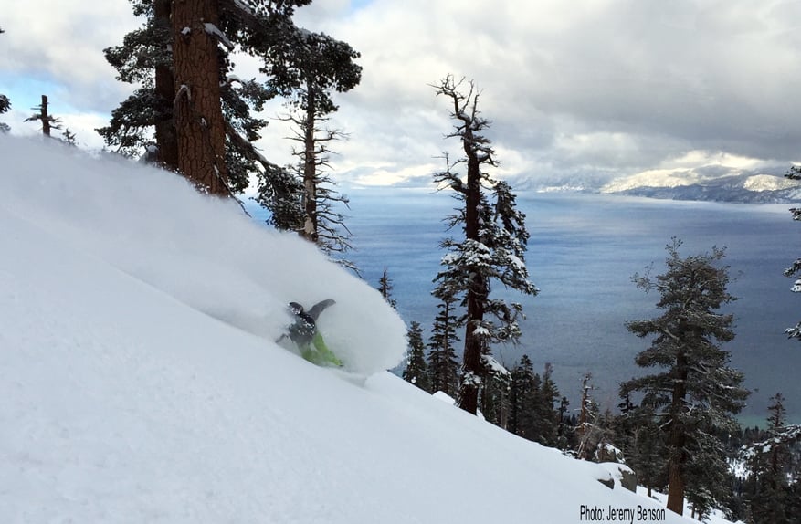 Backcountry rider in a wave of powder above Lake Tahoe